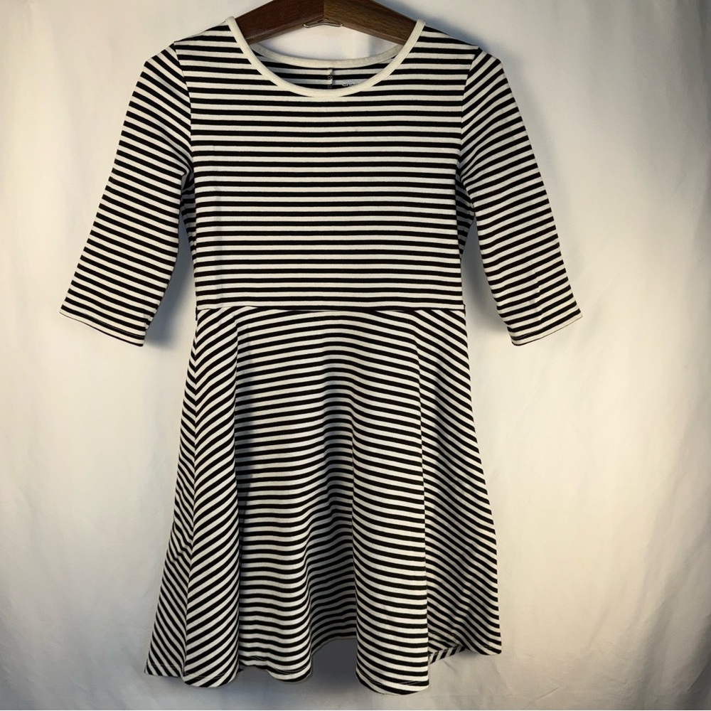 A plain white and black striped dress. 14-16 (XL) in kids